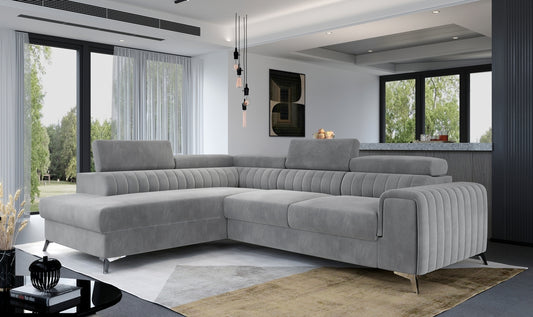 Gray sectional sofa in a modern living room with large windows.