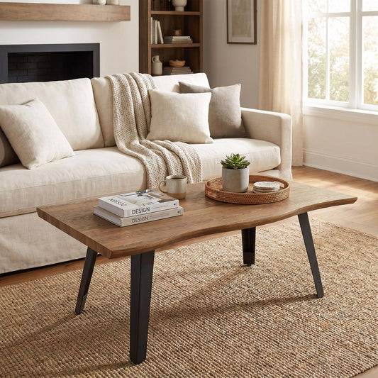 A live-edge wooden coffee table with black metal legs in a bright, modern living room setting.