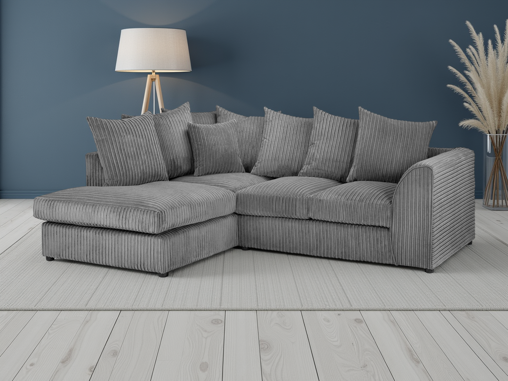 Gray sectional sofa in a room with a lamp and decorative plant.