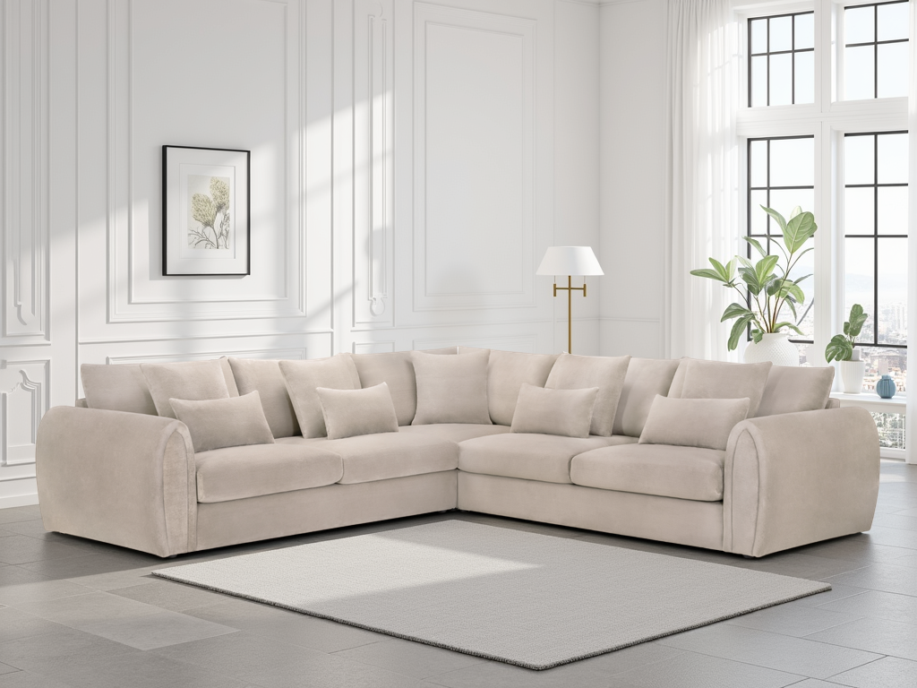 Beige sectional sofa in a living room with white walls and decor.