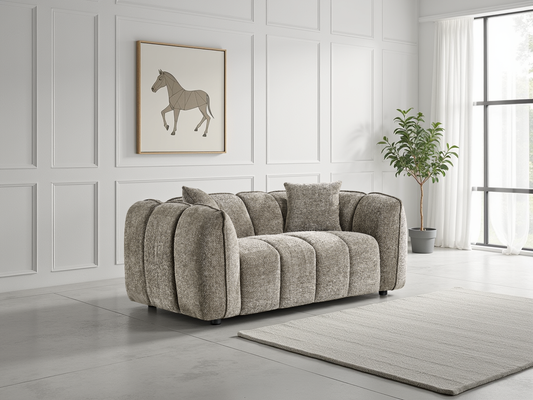 Beige sofa in a room with white paneled walls, a horse painting, and a plant.