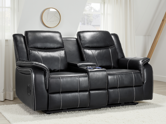 Black leather recliner sofa in a living room setting with a mirror and window in the background.