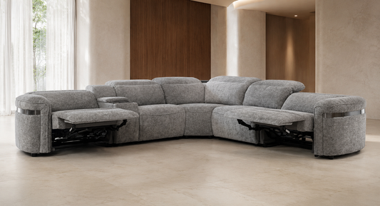 A curved modular sectional sofa upholstered in textured light gray fabric, shown with both outer chaise sections extended in a modern minimalist room.