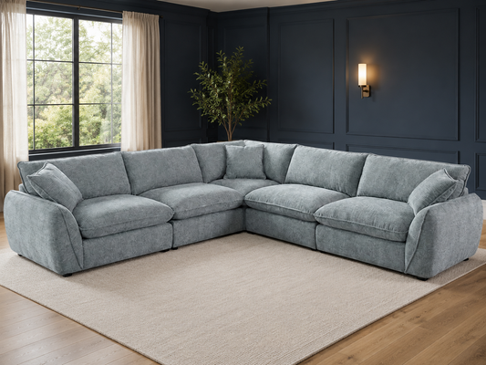 A light gray upholstered sectional sofa arranged in an L-shape in a modern living room.