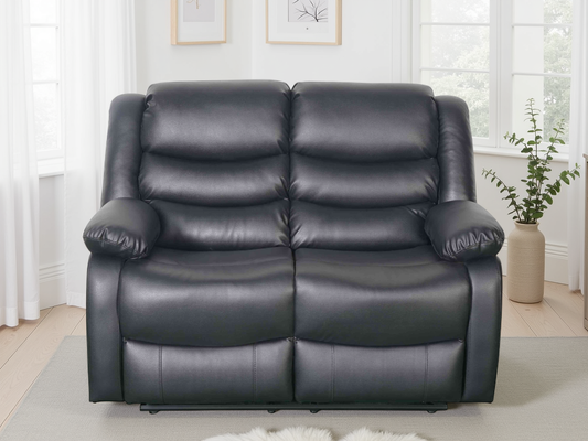 Black leather sofa in a living room setting with a neutral color palette.