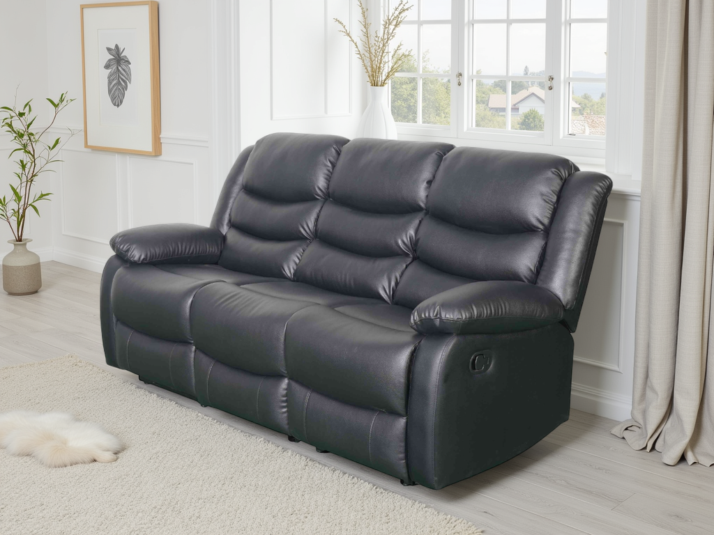 Black leather sofa in a living room setting with a window and plants in the background.