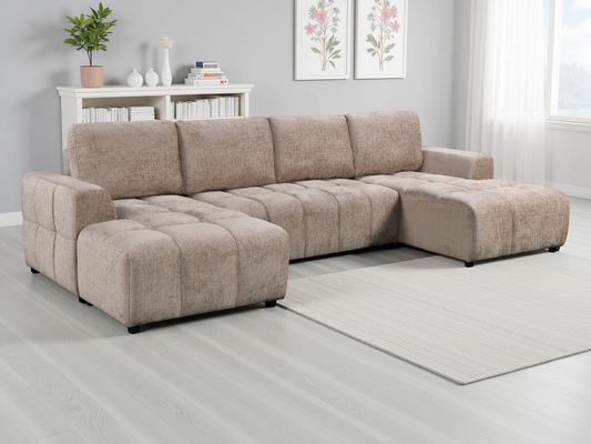 Beige sectional sofa in a living room setting with decor elements.