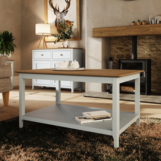 Wooden dining table with a white base in a living room setting.