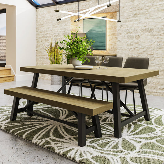 Dining area with wooden table, chairs, and bench on a patterned rug.