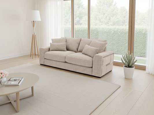 Beige sofa in a modern living room with large windows and minimal decor.