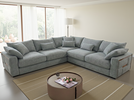 Gray sectional sofa in a living room with a coffee table and decor.