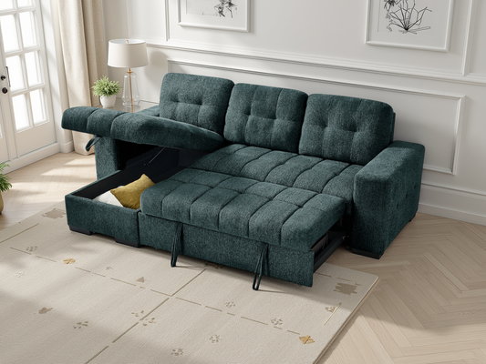 Green sectional sofa with pull-out bed in a room with light wood flooring and white walls.