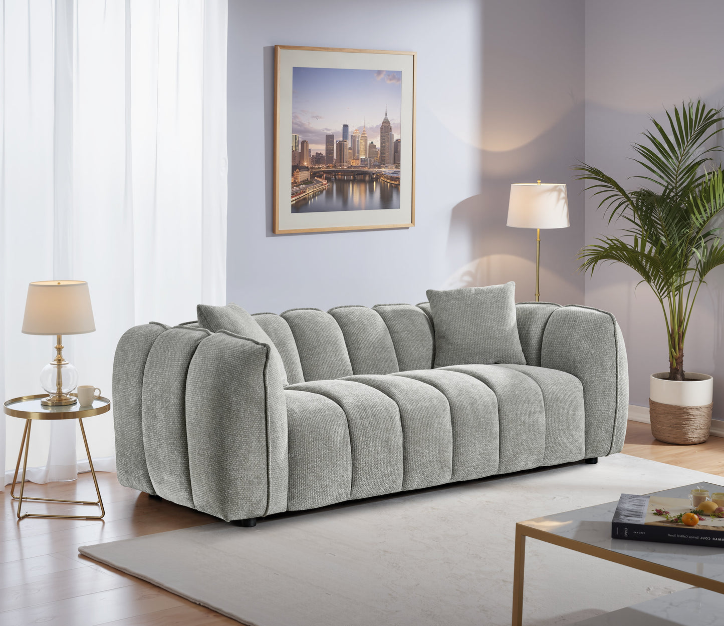Gray sofa in a living room with a cityscape painting on the wall.
