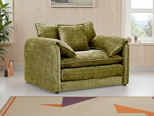 Green sofa in a living room with a plant and window in the background