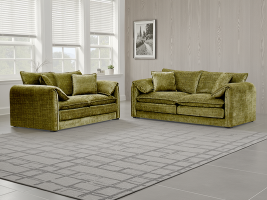 Two green sofas in a room with large windows and a gray floor.