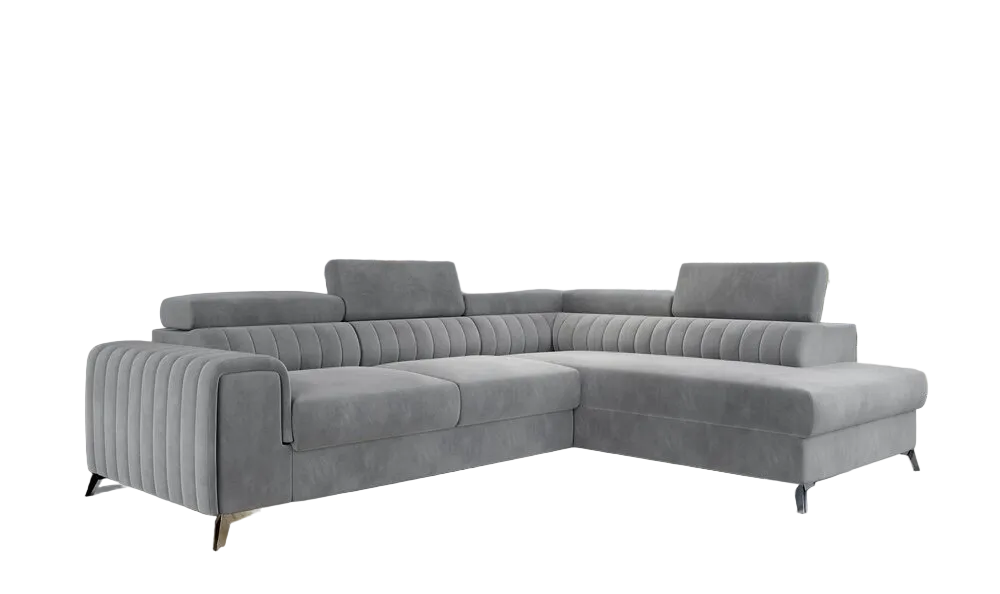 A modern light grey tufted sectional sofa with a chaise lounge, shown in a contemporary living room.