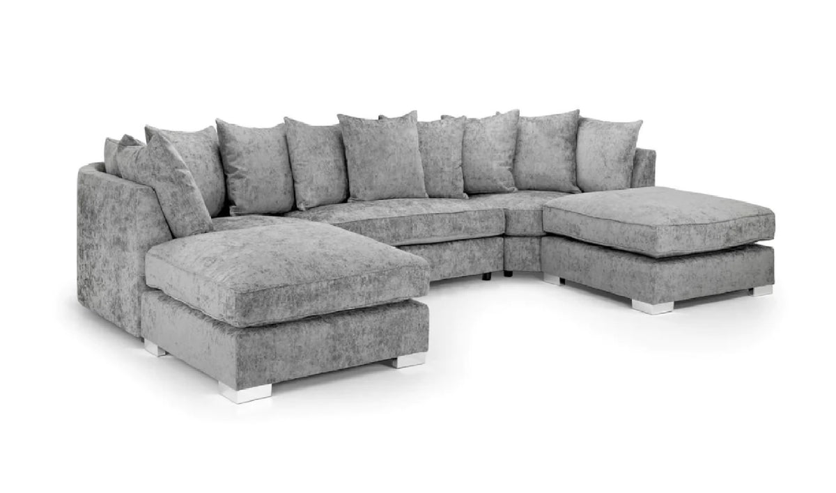 A gray upholstered sectional sofa with multiple matching throw pillows, a chaise ottoman on the left, and a right-facing chaise ottoman, shown on a plain white background.