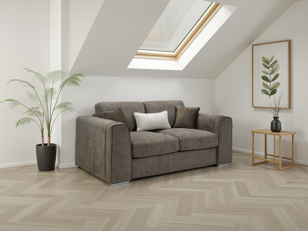 Gray sofa in a room with a skylight, plant, and side table.