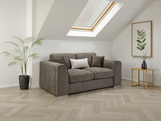 Gray sofa in a room with a skylight, plant, and side table.