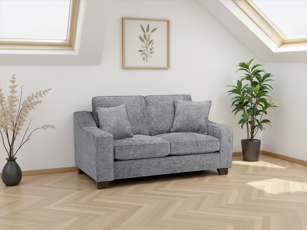 Gray sofa in a living room with plants and decorative items.