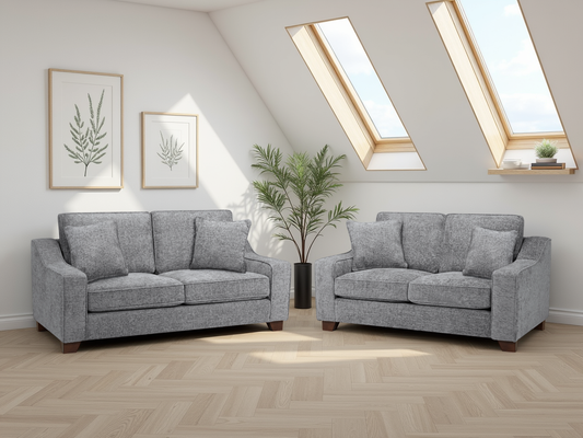 Gray sofa set in a room with skylights and decorative plants.
