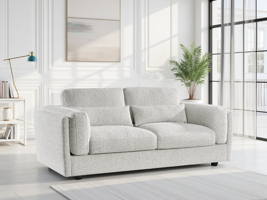 Beige sofa in a modern living room with large windows and a plant.
