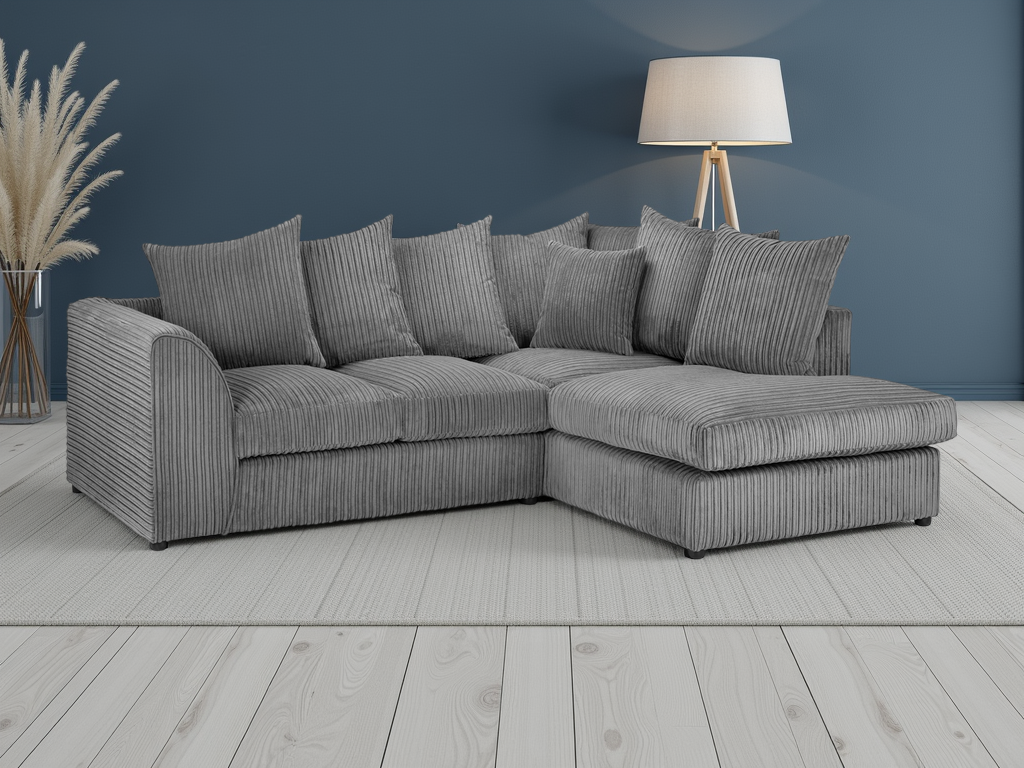 Gray sectional sofa in a room with a blue wall and wooden floor.