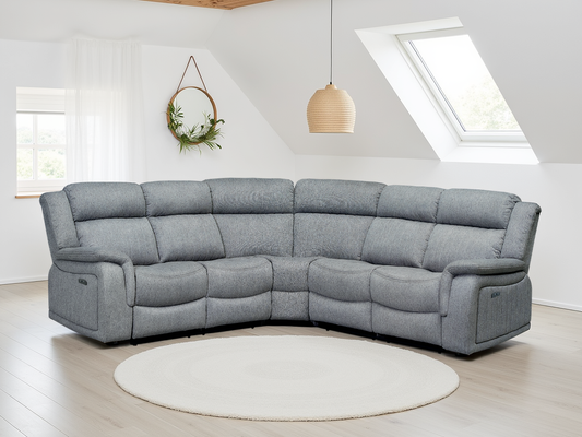 Gray sectional sofa in a modern living room with white walls and a skylight.