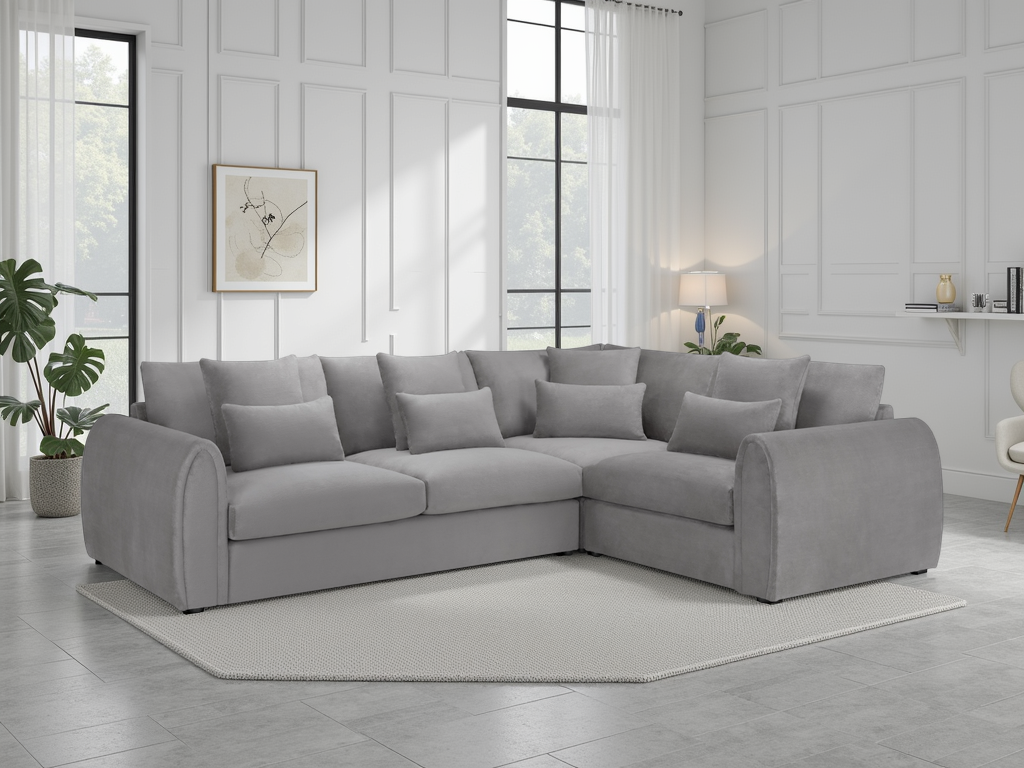 Gray sectional sofa in a modern living room with white walls and large windows.