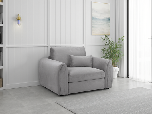 Gray armchair in a modern living room with white walls and a plant.