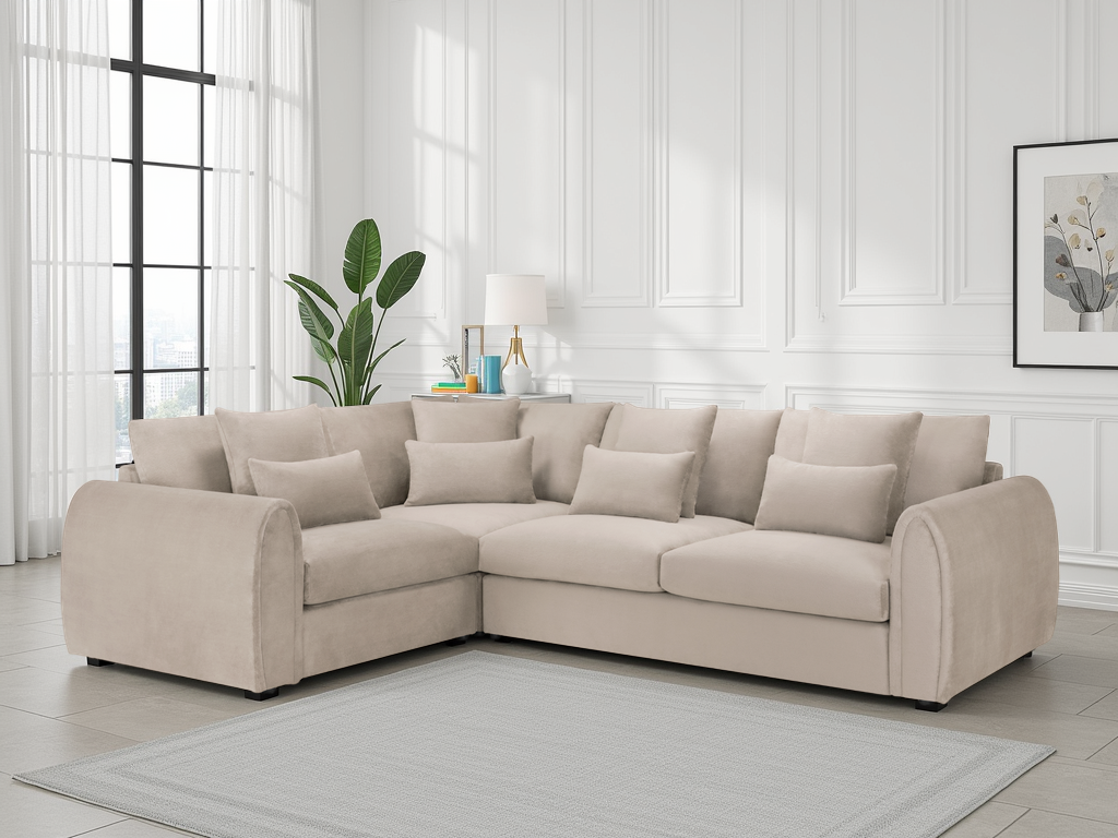 Beige sectional sofa in a living room with white walls and a plant.