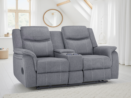 Gray recliner sofa in a bright room with large windows.