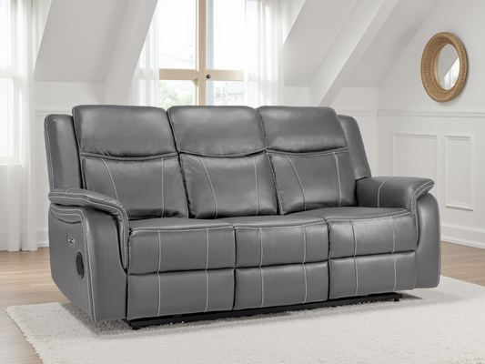 Gray leather sofa in a living room setting with white walls and a window.