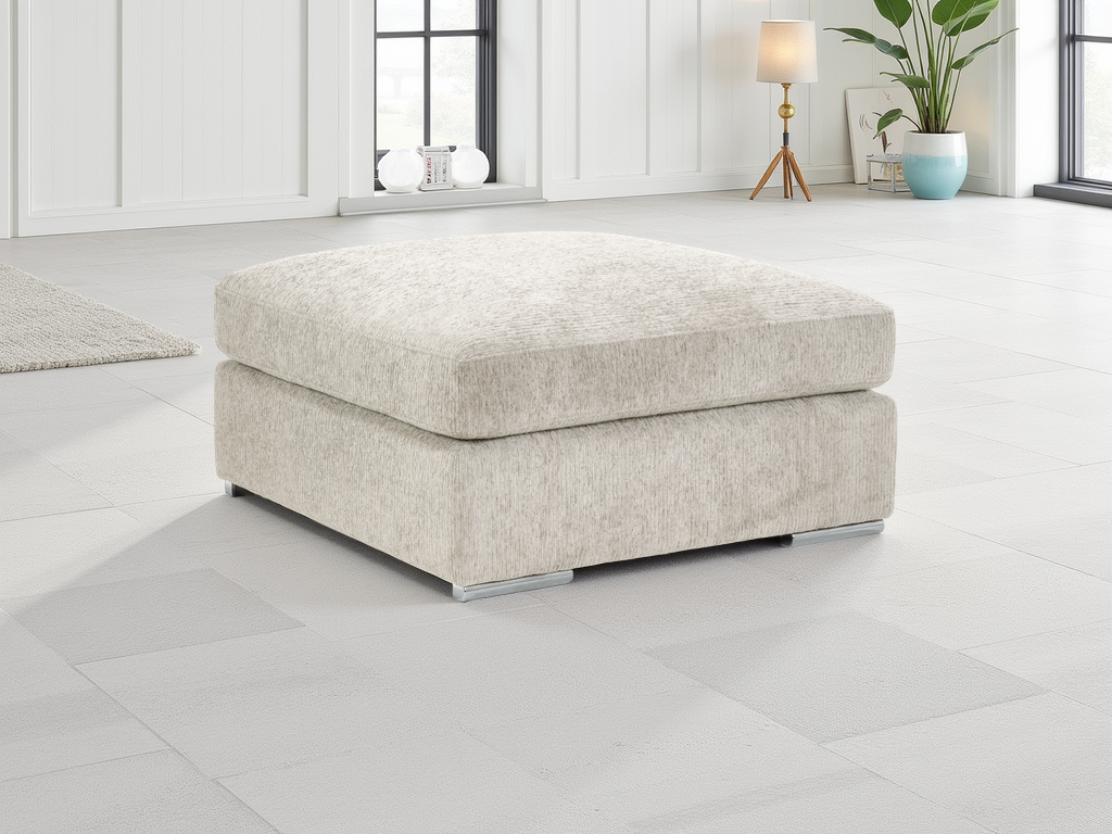 Beige ottoman in a modern living room setting with white walls and a plant.