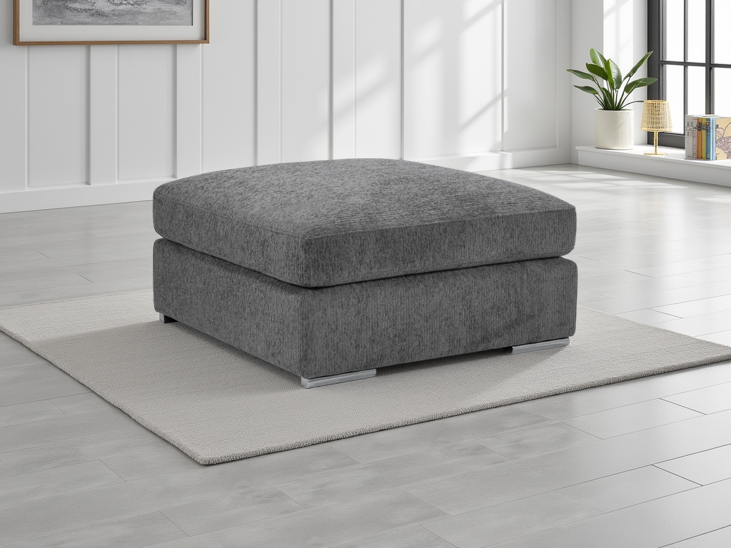 Gray ottoman in a room with light wood flooring and a window in the background.