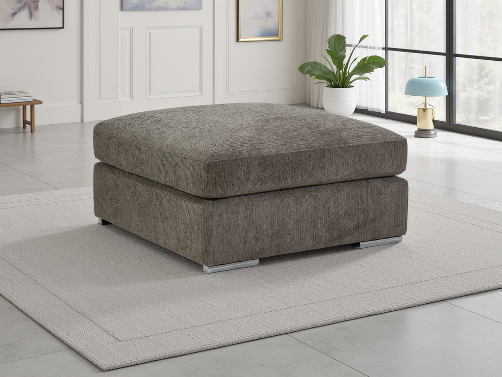 Gray ottoman in a modern living room with a plant and rug.