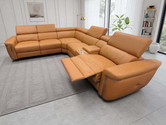 Tan sectional sofa in a modern living room setting with large windows and decor.