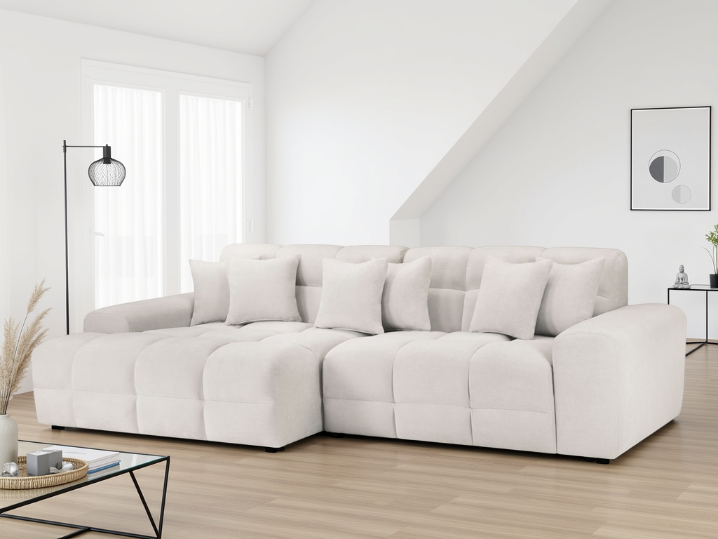 White sectional sofa in a modern living room with a neutral color scheme.