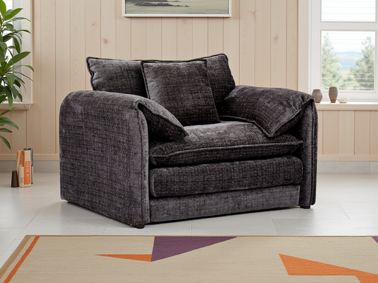 Black sofa in a room with a plant and window
