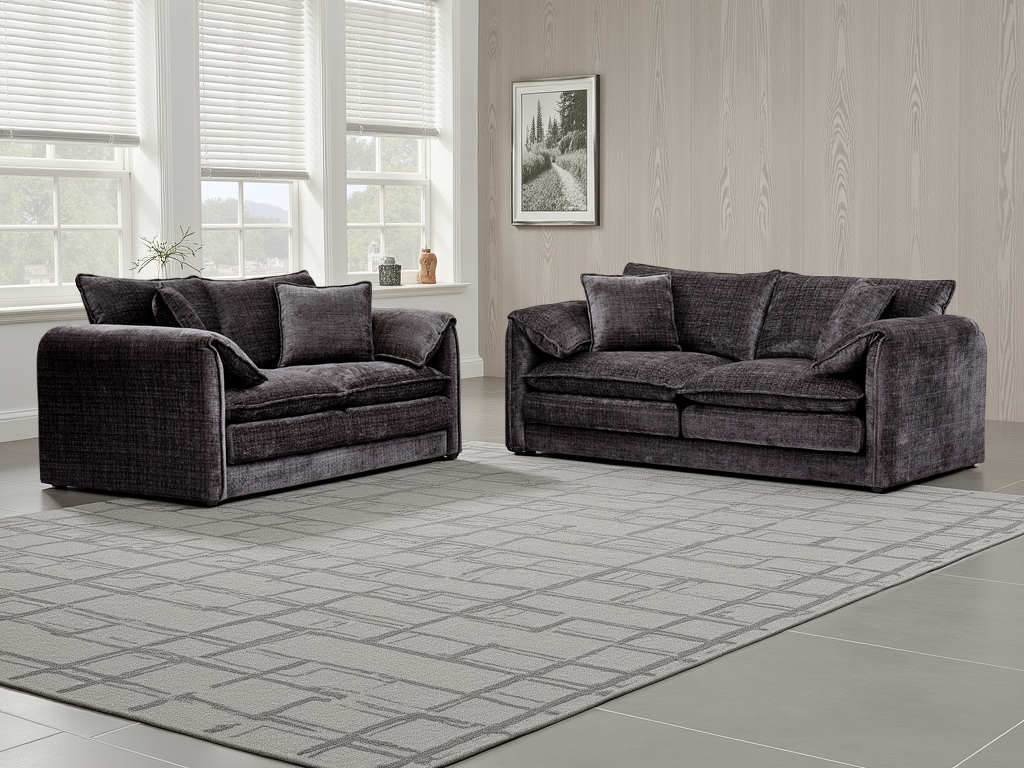 Black sofa set in a room with large windows and a framed picture on the wall.