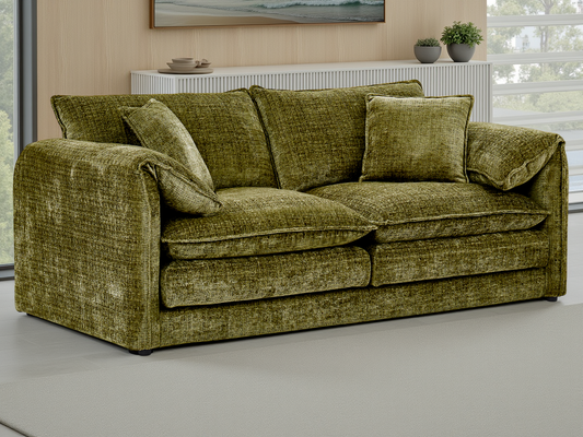 Green sofa in a living room setting with decor elements.