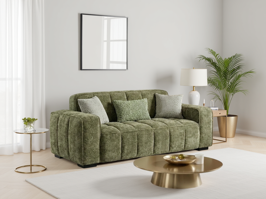 Green sofa in a modern living room with a gold coffee table and decorative items.