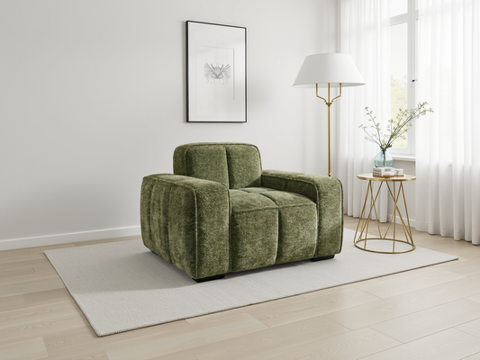Green armchair in a modern living room with a lamp and small table.