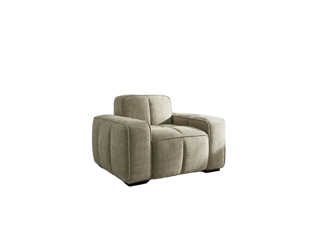 A modern low-profile armchair upholstered in a textured light beige fabric, featuring a low boxy frame and dark feet, shown against a plain white background.