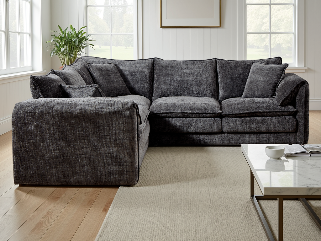 Black sectional sofa in a living room with a coffee table and decor.