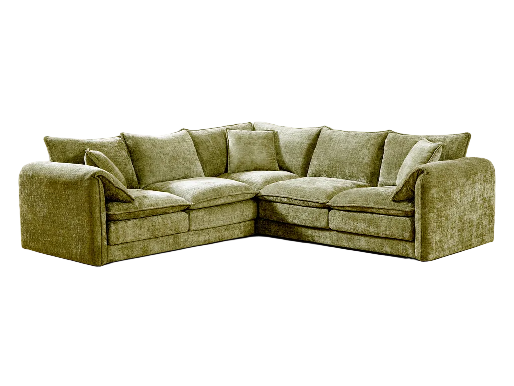 Green sectional sofa in a bright room with a small table and plant.