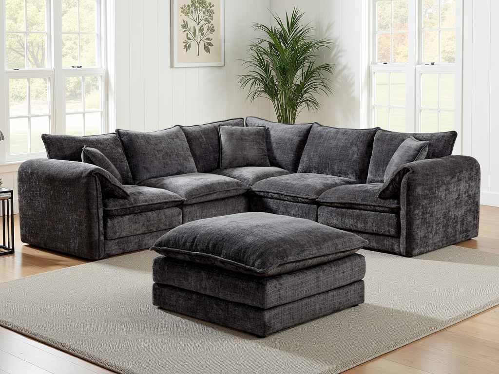 Black sectional sofa with ottoman in a living room setting