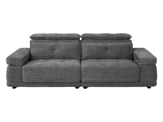 A modern gray fabric sectional sofa with tufted back cushions, shown in a bright, contemporary living room with a white background.