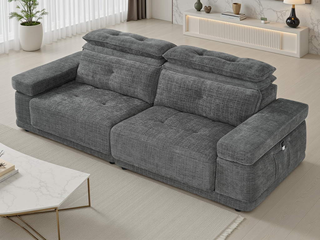 A modern gray fabric reclining sofa with tufted back cushions, shown in a bright, contemporary living room setting.