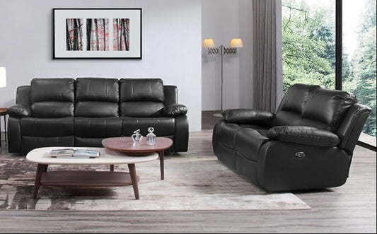 A modern living room setup featuring a black leather three-seater sofa and a matching black leather recliner chair.
